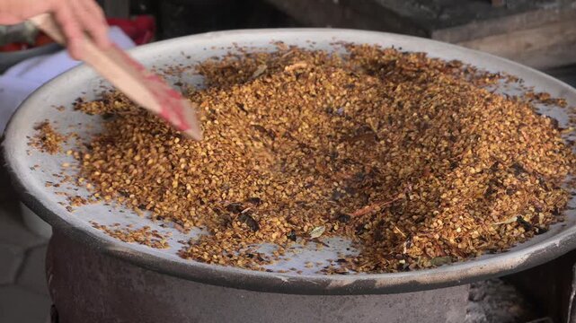 Toasting the chili seeds on the clay griddle