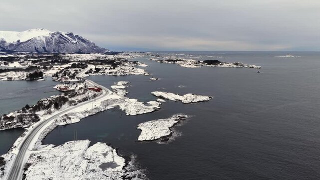 Aerial view of the snow covered landscape around the famous Atlantic Ocean Road connecting the municipalities Averoey and Hustad on the northwest coast of Norway.
