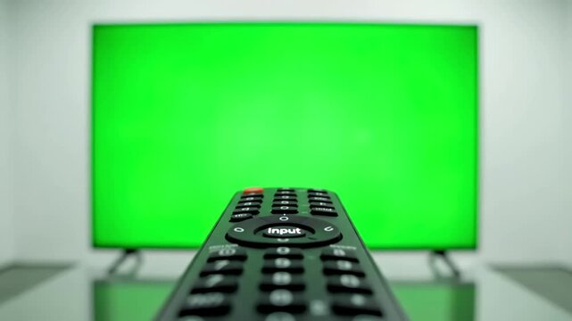Remote Control Interaction with person pointing a tv and pressing buttons in front of green screen distortion, overlay, glitch, static noise, scan lines on black background, 4k animated video loop