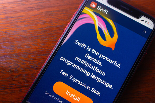 Quito, ECUADOR - Nov 25 2025 : Close-up of a smartphone displaying the Swift programming language website with install button and colorful logo on screen.