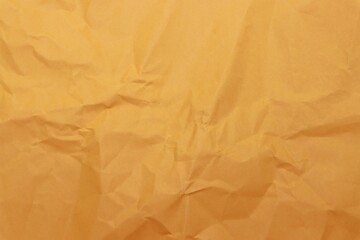 Fototapeta premium Wrinkled orange craft paper texture background