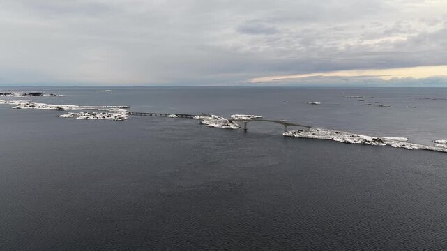 Aerial view of the snow covered landscape around the famous Atlantic Ocean Road connecting the municipalities Averoey and Hustad on the northwest coast of Norway.