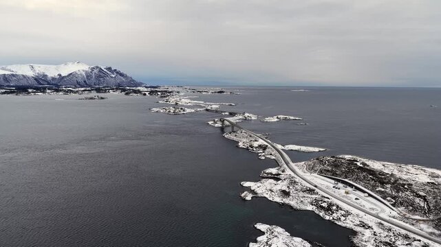 Aerial view of the snow covered landscape around the famous Atlantic Ocean Road connecting the municipalities Averoey and Hustad on the northwest coast of Norway.