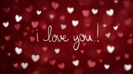 a beautiful red background with numerous white and pink hearts, with the words i love you! in cursive writing at the center. the text is white on a dark red background. there's a subtle bokeh effect a
