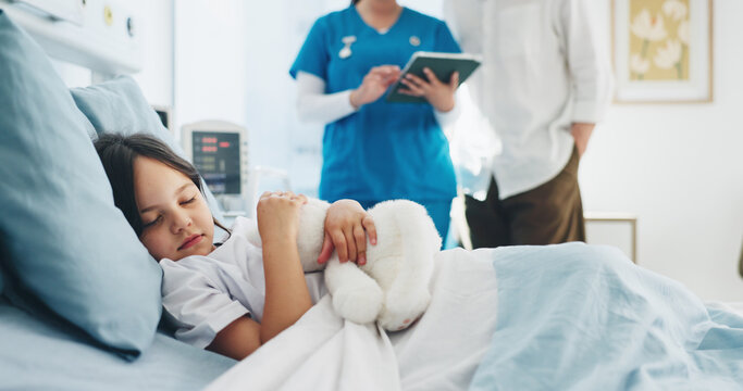 Sleeping, child and girl with teddy bear, hospital and nurse with tablet for diagnosis or healthcare. Sick, kid and rest on bed with plush toy, dad and discussion with pediatric for medical report