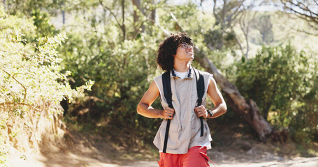 Obraz premium Man, happy and thinking with hiking in forest for adventure, outdoor and getaway on holiday. Person, smile and nature tourism with perspective for reflection, break or view with trekking in woods