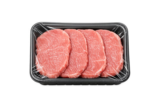 Raw beef steaks in black plastic tray