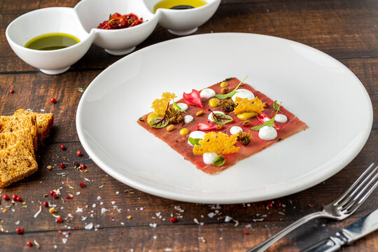Modern Italian carpaccio plate with artistic fine dining presentation