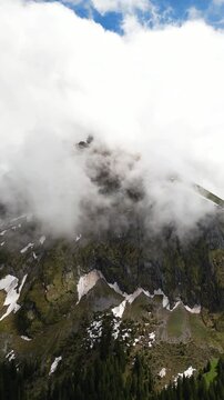 Fronalpstock Alps rocky mountain landscape partially obscured by clouds mist Switzerland aerial