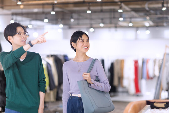 ブティックで指差す方向を見るカップル