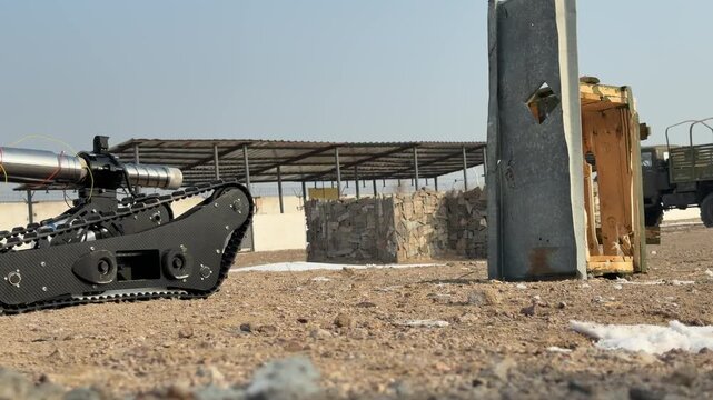 The sapper robot demonstrates the neutralization and destruction of improvised explosive devices. Military exercises. Slow motion. 