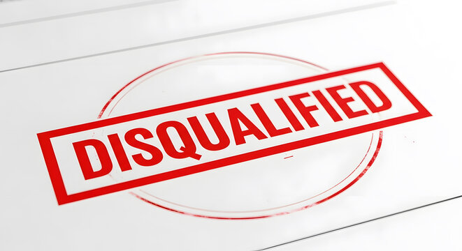 Red rubber stamp with the word disqualified printed on a white paper background
