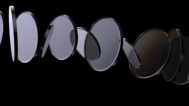 Loop 3d animation. Translucent glass blocks spin and rotate on black background, round lenses.