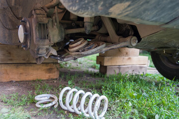 Broken spring in the car suspension.