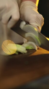 Woman chopping onion in modern kitchen