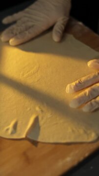 Female baker preparing dough for homemade pastry