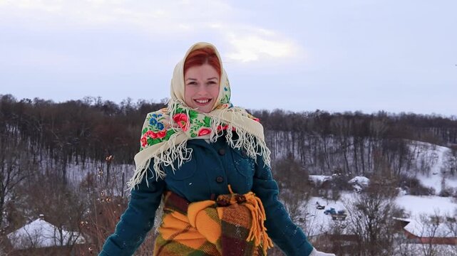 Joyful young woman during a winter walk in nature. Snow, activity, sincere emotions and seasonal mood.