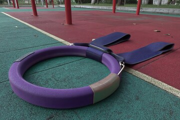 Outdoor gym equipment features a safe rubber surface in urban settings.