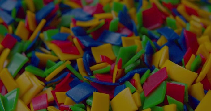 Lots of small brightly pieces of shredded household plastic destined for recycling.