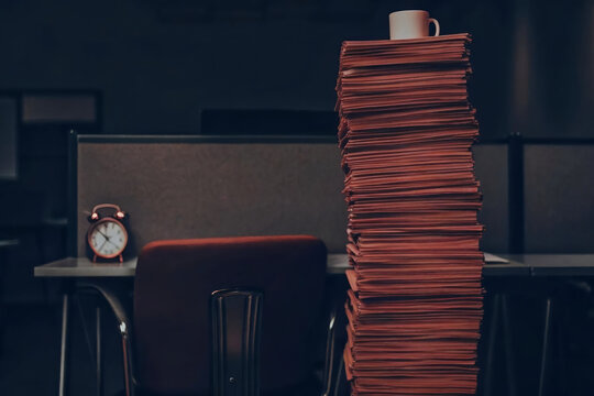 Office paperwork document stack paper cup clock desk, towering file pile beside cubicle chair, dim light suggesting overtime stress, bureaucracy, deadline pressure, surreal routine