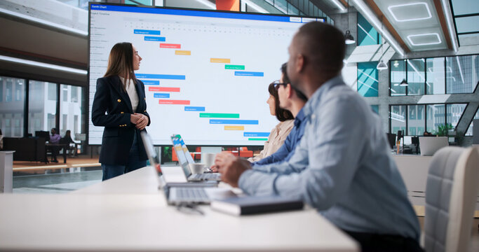 Multiracial Team Meeting In Office Discussing Time Plans