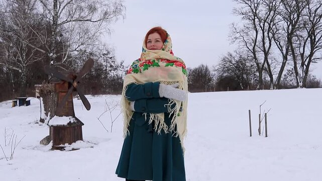 Joyful young woman during a winter walk in nature. Snow, activity, sincere emotions and seasonal mood.