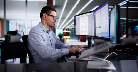 Fototapeta premium Young Hispanic Accountant Calculating Tax Invoices On Laptop