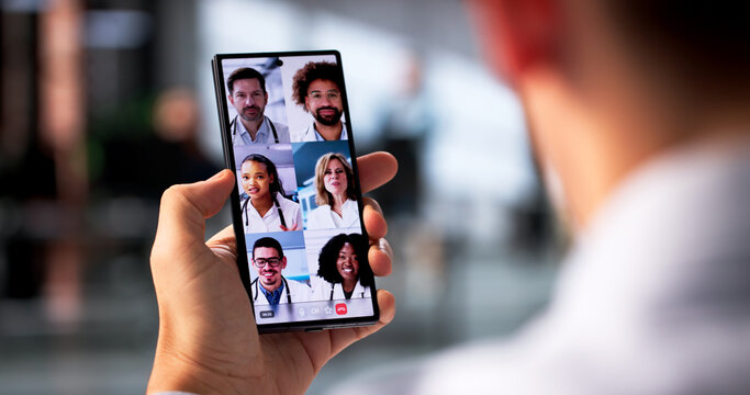 Young Hispanic Man Attending Telehealth Conference With Doctors