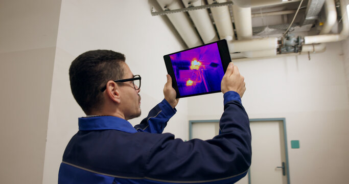 Engineer Using Thermal Camera To Check Heat Loss