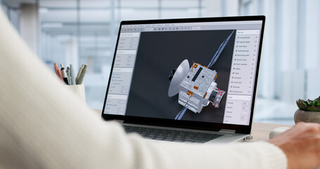 Female Engineer Designs Satellite With Solar Panels On Laptop © Andrey Popov