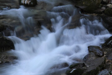 River with vivid rocks, stones, waterfalls and fog like water in the air.