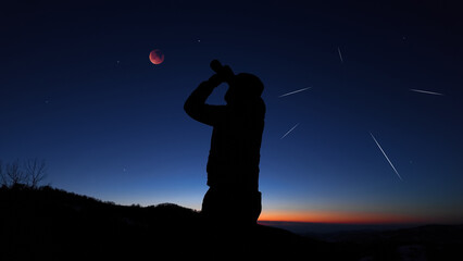 Fototapeta premium Amateur astronomer observing stars, planets, Moon eclipse and other celestial objects.