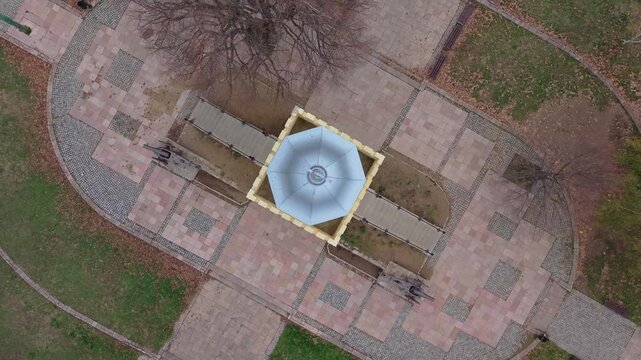 A top-down drone shot of the Cegar Monument as altitude increases, revealing the full historic landmark and its surrounding landscape, highlighting its significance in Serbian history.