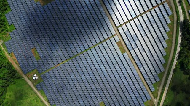 High-altitude aerial showing the solar energy facility within the wider land context of Palauig, Zambales.