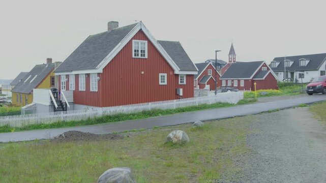 Nuuk Greenland 2025 city streets with Greenland flag and white picket fences.