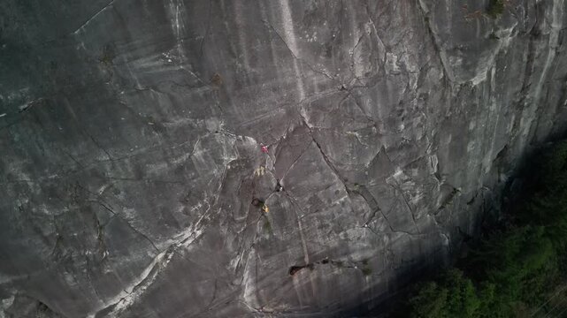 Drone footage of a rock climber scaling the vertical granite wall of Stawamus Chief in Squamish, British Columbia.