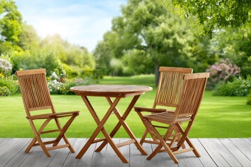 Wooden patio dining set in lush garden