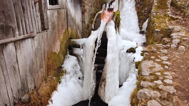  Frozen water mill with frozen water ice at winter in a village