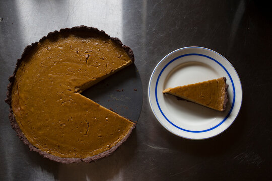 Top View of Pumpkin Pie and a Served Slice