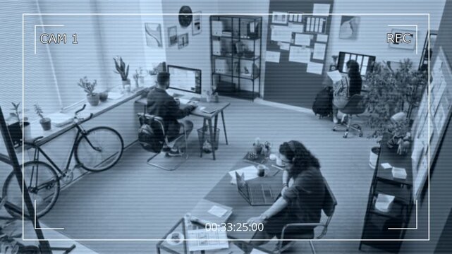 CCTV security camera effect shot of diverse UX designers working together on mobile applications in tech startup office, discussing concepts, man throwing hand gripper to colleague