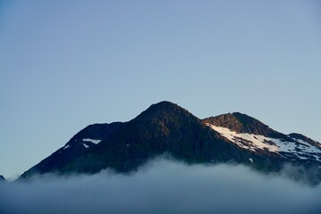 Clouds hugs the slopes of mount Keipen in Gullesfjordbotn, Norway.