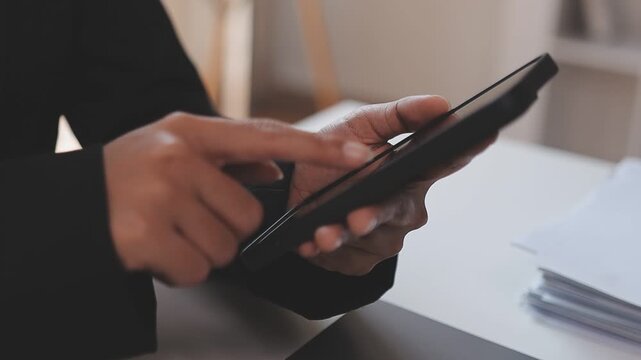 Young casual Businessman holding and using smartphone for sms messages, hipster man typing touchscreen cell phone in the cafe. business, lifestyle, technology and Social media network concept