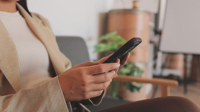 Young casual Businessman holding and using smartphone for sms messages, hipster man typing touchscreen cell phone in the cafe. business, lifestyle, technology and Social media network concept
