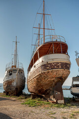 Naklejka premium Old wooden fishing boats on dry dock for repairs