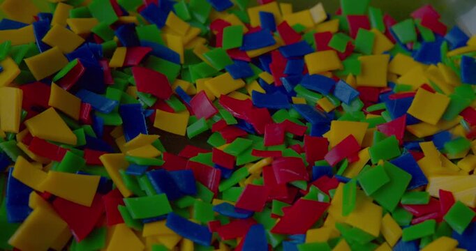 Detail close-up of small bright plastic scraps destined for recycling.