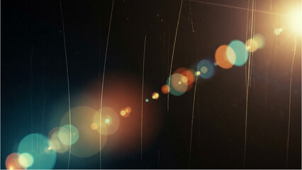 Fototapeta premium Rainbow lights and rain falling down on a dark background with lens flares from the top right