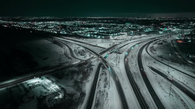 Night aerial view of snowy Mississauga 403 and QEW freeway interchange