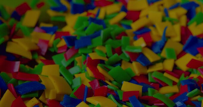 Detail close-up of small bright plastic scraps destined for recycling.