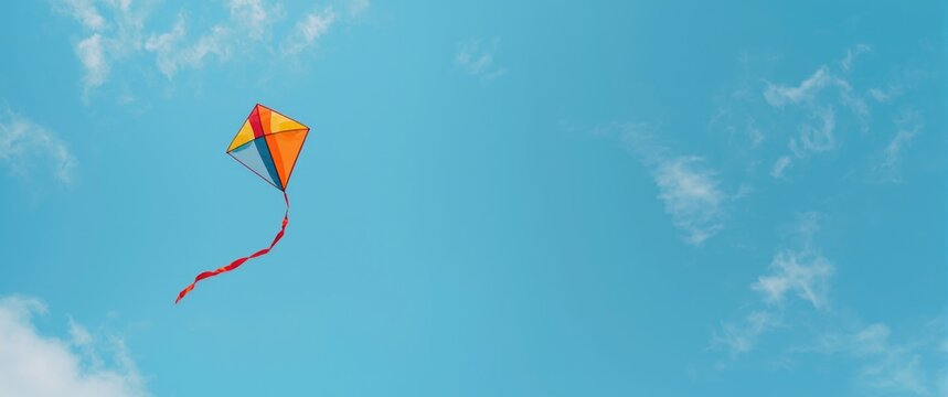 Brightly colored kite in the sky with blue background