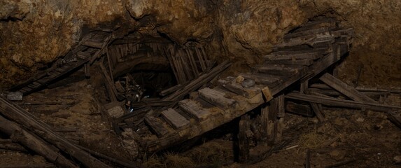 Fototapeta premium Collapsed wooden timbering inside underground tunnel of previous bauxite mine